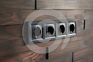 Electrical household switches and sockets close up. Minimalist interior design. Stylish bedroom and living room. Wooden