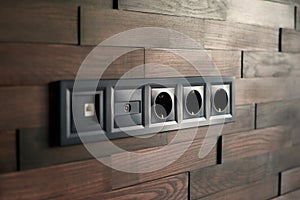 Electrical household switches and sockets close up. Minimalist interior design. Stylish bedroom and livingroom. Wooden