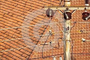 Electrical installation network with concrete poles on the streets side by side with people\'s houses in Indonesia