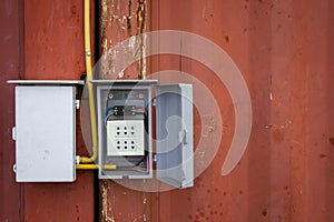 Electrical installation of outdoor cables on old cargo container.