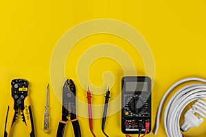 Electrical installation tools on yellow background