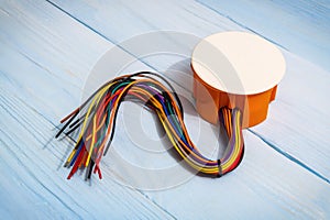 The electrical junction box with wires on blue boards usually used in the electric installation process