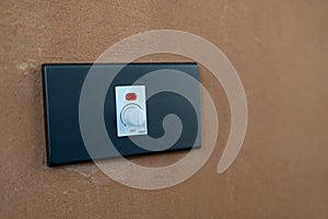 Electrical light dimmer switch on brick wall