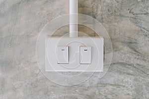 Electrical light switch on cement wall background