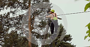 Electrical lineman connecting wires on electric pole. powerline maintenance and repair