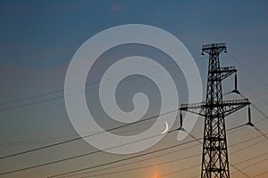 Electrical lines under a night sky with moon