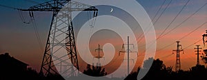 Electrical lines under a night sky with moon