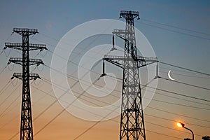 Electrical lines under a night sky with moon