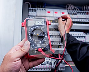 Electrical measurements with multimeter tester. Modern electrical background.