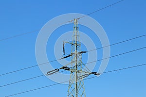 Electrical network of high voltage. Transportation of electricity through the high-voltage line. Metal tower with wires and cables