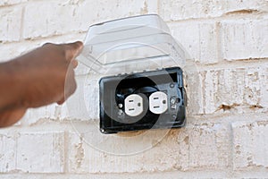 Electrical outlet outside with rain cover photo
