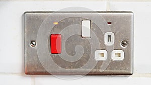 Electrical outlet and switch panel with red button and indicator light
