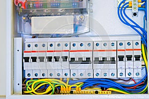 Electrical panel with a lot of wires and switches. Cabling is connected to circuit breakers. Automatic power distribution system.