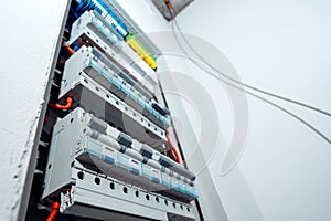 Electrical panel with multiple automatic circuit breakers and connected wires