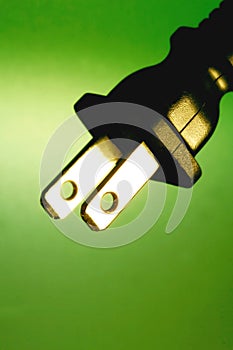 Electrical plug against green background