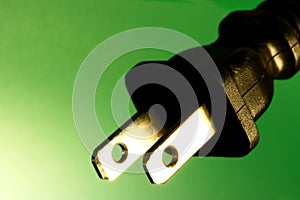 Electrical plug against green background