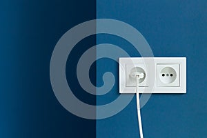 Electrical plug in electric double socket on wall