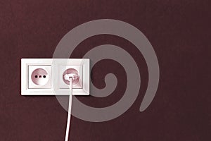 Electrical plug in electric double socket on wall