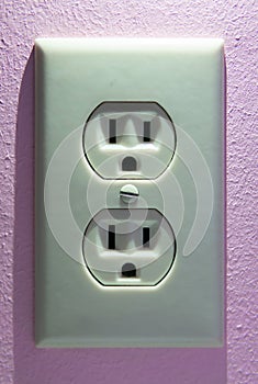 Electrical Plug on a Pink Wall