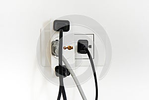 Electrical plug and socket overloaded on white background