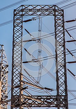 Electrical poles of high voltage with electric pole power lines and wires with blue sky. High voltage equipment on an electric