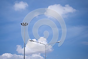 Electrical poles, sports line poles with small birds perched on a bright sky background