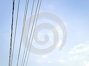 Electrical power junction at the pole reveals the complexity with the bright blue sky clouds
