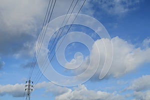 Electrical power lines with blue sky and white cloud