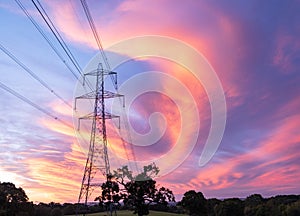 Electrical power lines and towers at sunset.