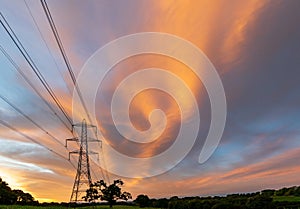 Electrical power lines and towers at sunset.