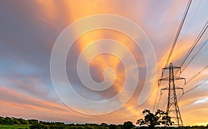 Electrical power lines and towers at sunset.