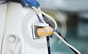 Electrical power socket bollard on pier. Charging station for boats in Marina. Electrical outlets to charge ships in harbor.