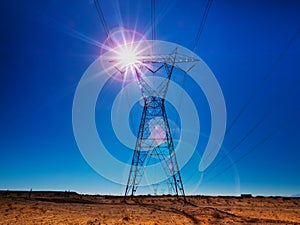 Electrical power tower back lit by the sun