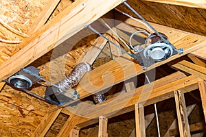 Electrical recessed can lights and vents during new construction photo