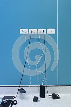 An electrical socket full of wires for charging