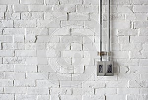 Electrical Socket on a White Painted Brick Wall