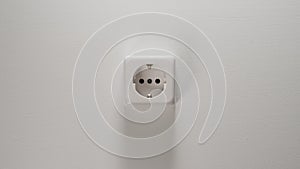 Electrical Socket On A White Wall