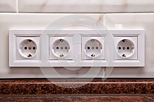 Electrical sockets on a kitchen tile wall