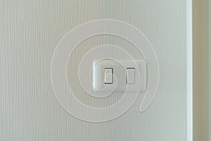 Electrical switch on white wall background