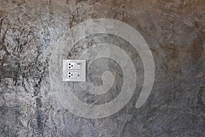 Electrical switches and sockets on the cement wall.