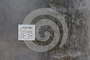 Electrical switches and sockets on the cement wall.