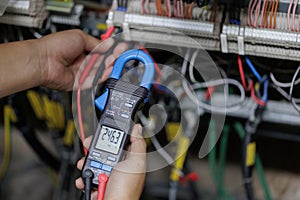Electrical Technician Taking Voltage Reading with Multimeter