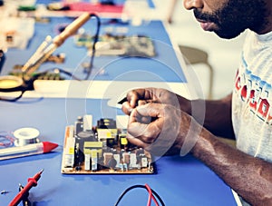 Electrical technician working on electronic board