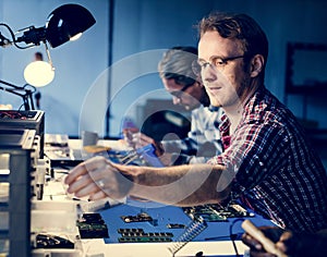 Electrical technicians working on electronics parts