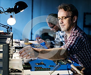 Electrical technicians working on electronics parts