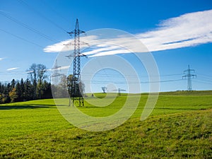 Electrical Tower on a field blue sky green grass