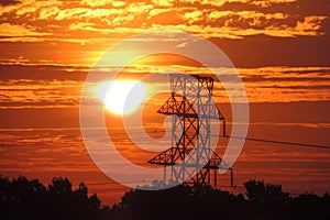 Electrical tower grid`s Silhouette in sunrise