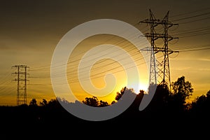 Electrical Tranmission Towers Against Golden Sky