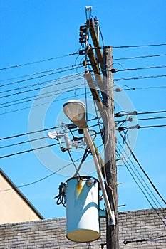 Electrical transformer attached to the electric post with electric cables