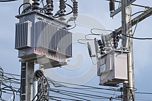 Electrical transformers on a power pole in Thailand, high voltage and power supply.